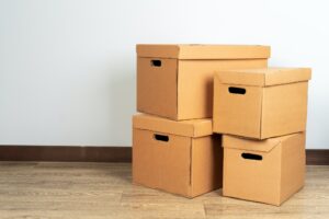 Group of brown carton boxes on wooden floor