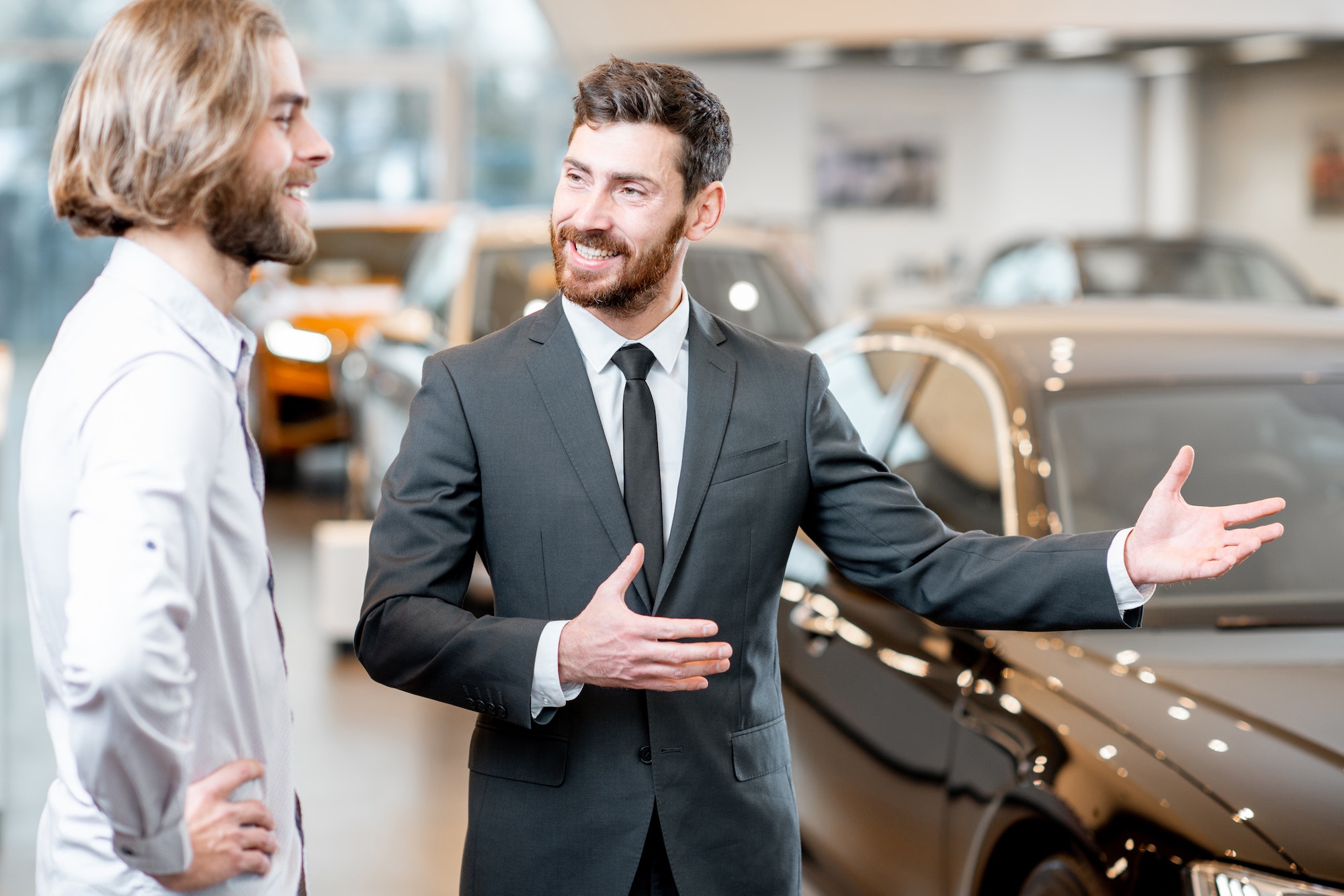 Salesperson with client in the car showroom